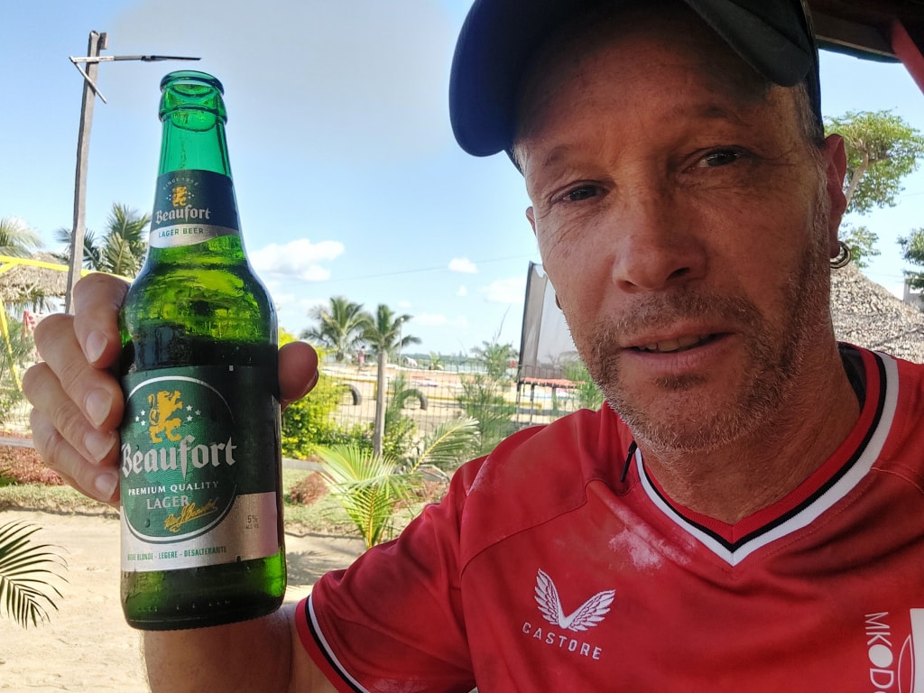 Nomadic Backpacker drink a Beaufort beer in Madagascar