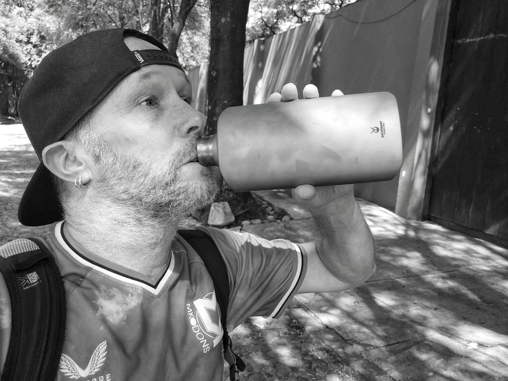 Nomadic Backpacker drinking from a SilverAnt Titanium Water Bottle