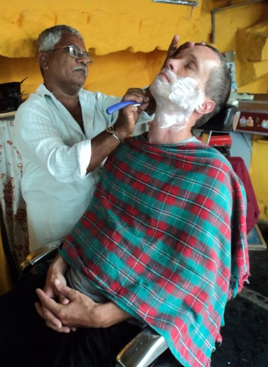 Nomadic Backpacker getting a shave in Hampi India